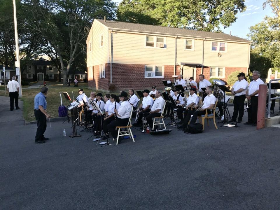 Retired Taunton City Band conductor Louis Perry, 88, guides the orchestra through during a concert at the Cedarvale Homes apartment complex on July 26, 2022.