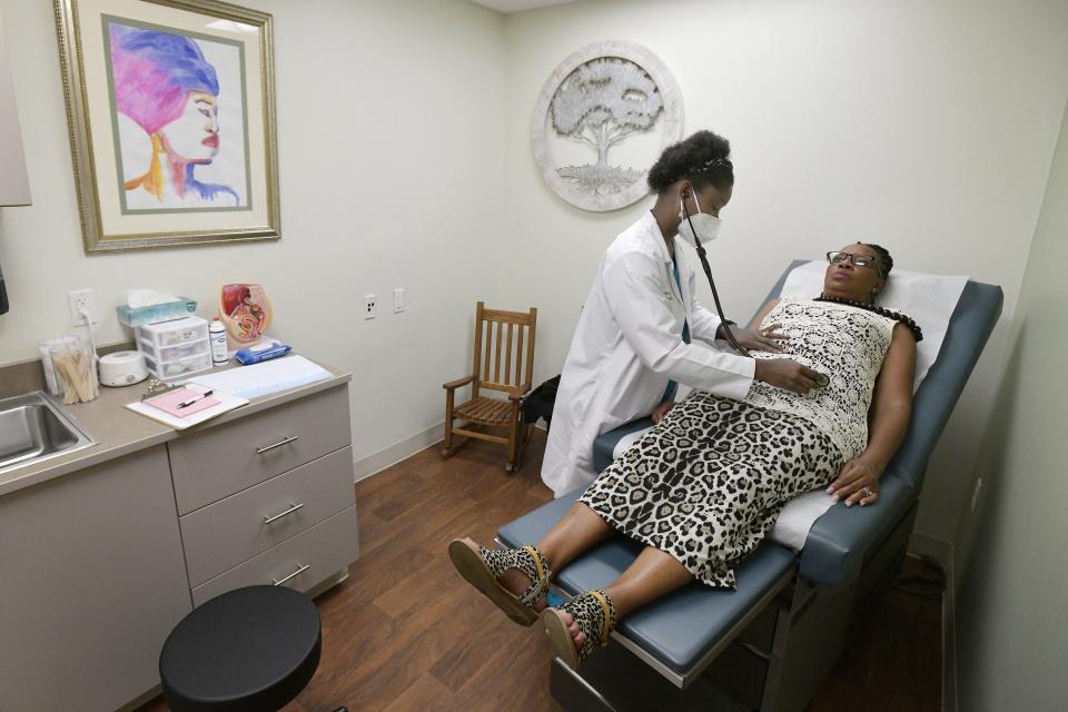 Registered nurse practitioner Jamie Neal and Jacqueline Fletcher meet for a routine first patient visit to establish a new source of primary care for Fletcher at Life Tree Women Care.