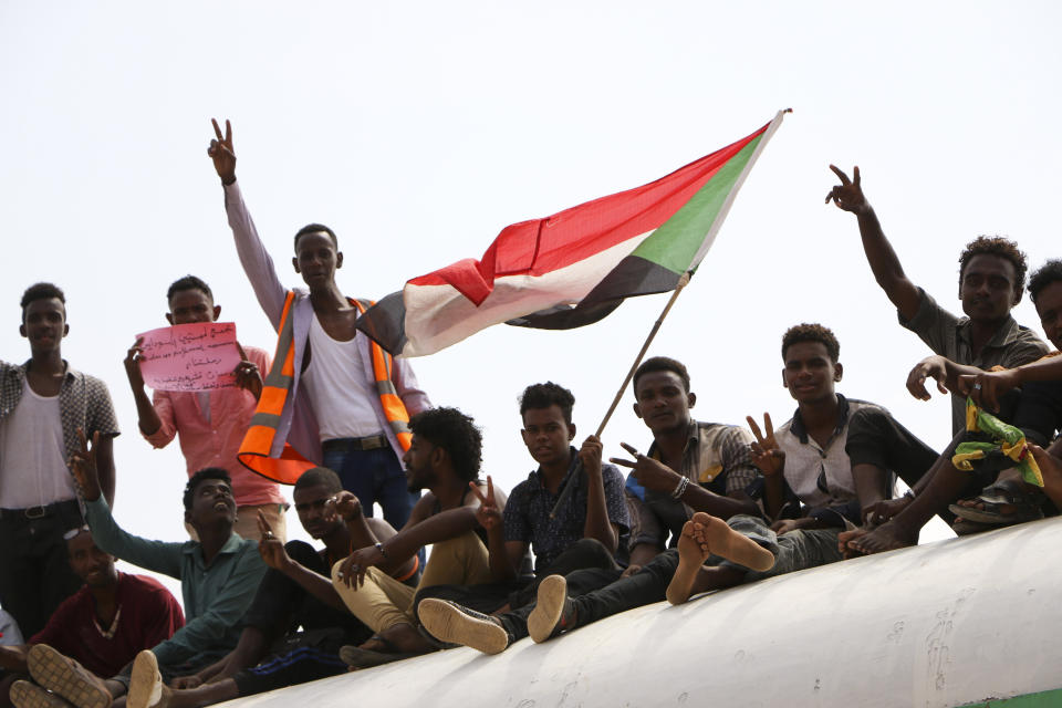 Sudanese pro-democracy supporters celebrate a final power-sharing agreement with the ruling military council Saturday, Aug 17, 2019, in the capital, Khartoum. The deal paves the way for a transition to civilian-led government following the overthrow of President Omar al-Bashir in April. (AP Photo)