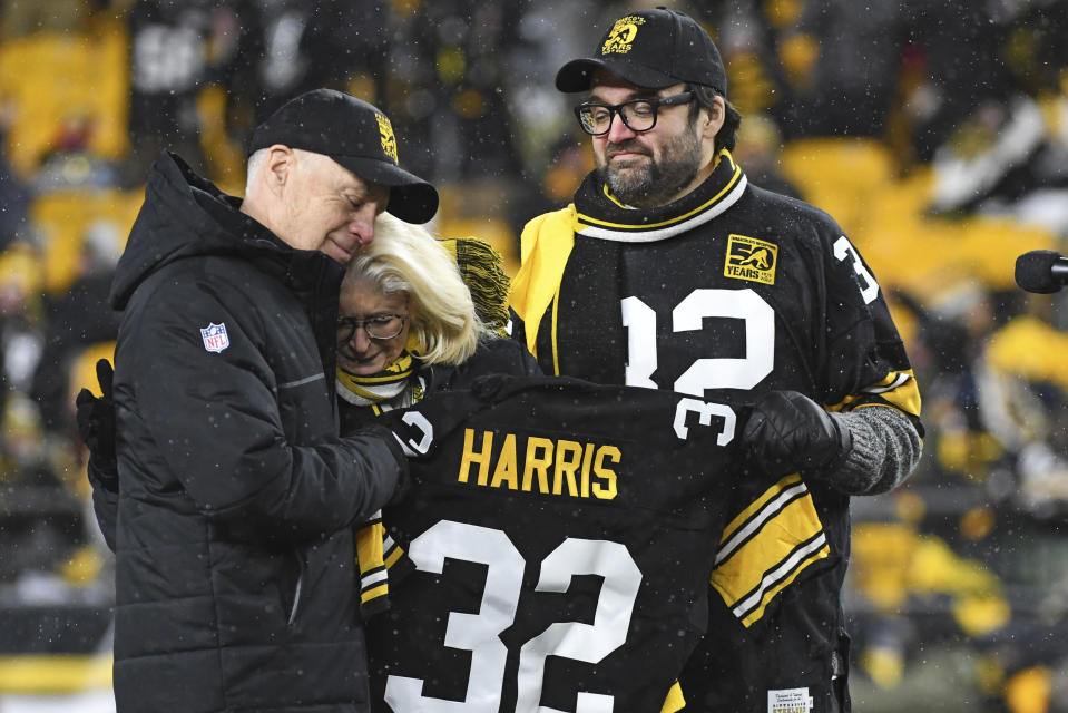 Pittsburgh Steelers owner Art Rooney II, left, Franco Harris' widow Dana, center, and son Dok attend a ceremony to retire Harris' No. 32 jersey at half-time of an NFL football game against the Las Vegas Raiders, Saturday, Dec. 24, 2022. Harris, a four-time Super Bowl champion, passed away Dec. 21, 2022, at the age of 72. (AP Photo/Fred Vuich)
