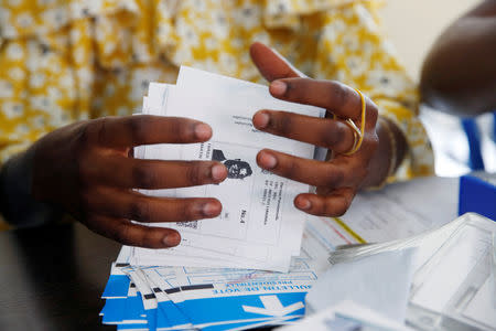 A Congo's Independent National Electoral Commission (CENI) official holds a ballot of Martin Fayulu, Congolese joint opposition Presidential candidate during the counting of presidential elections ballots at tallying centre in Kinshasa, Democratic Republic of Congo, January 4, 2019. REUTERS/Baz Ratner/Files