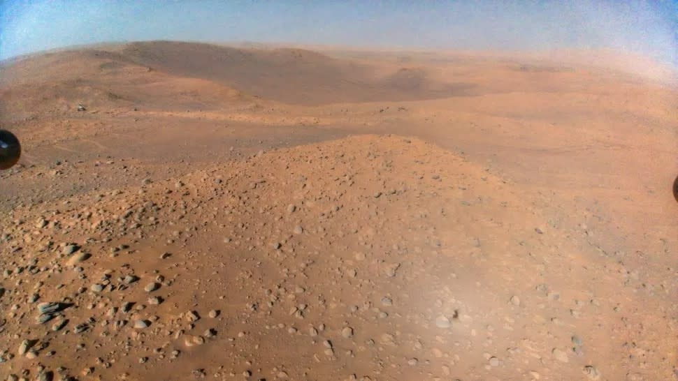  NASA's Perseverance rover can be seen in the background, while rocks and red Martian soil take up the rest of the image. 