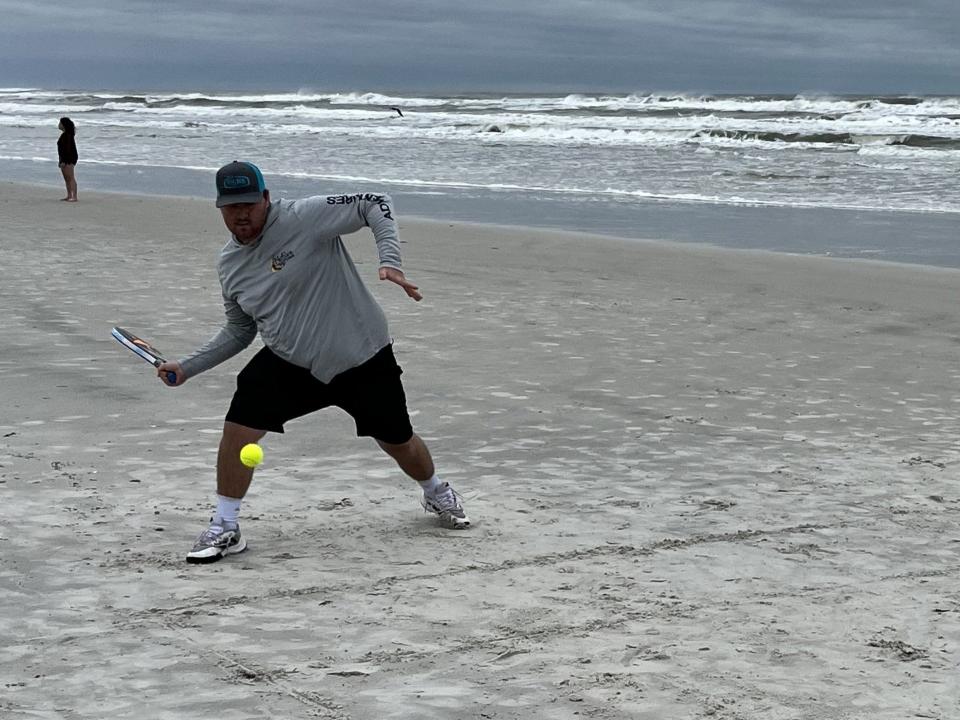 Jacob Carr of St. Augustine returns a shot during a warmup for his match in the 50th annual National Beach Pop Tennis tournament.