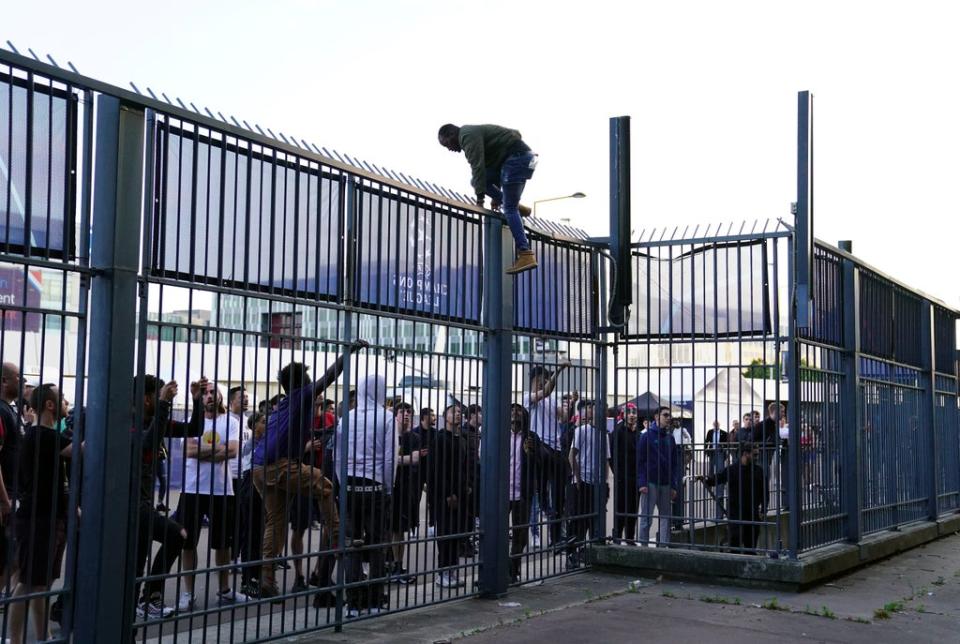 People try to climb gates outside the ground (Adam Davy/PA) (PA Wire)