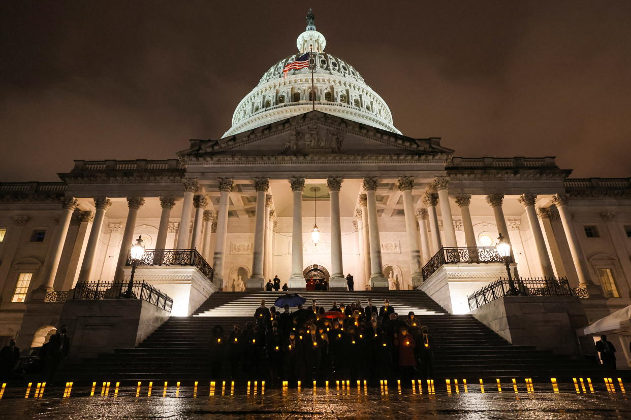 House Speaker Nancy Pelosi and members of Congress participate in a moment of silence to mark 900,000 U.S. lives lost to the pandemic, on Feb. 7, 2022. 