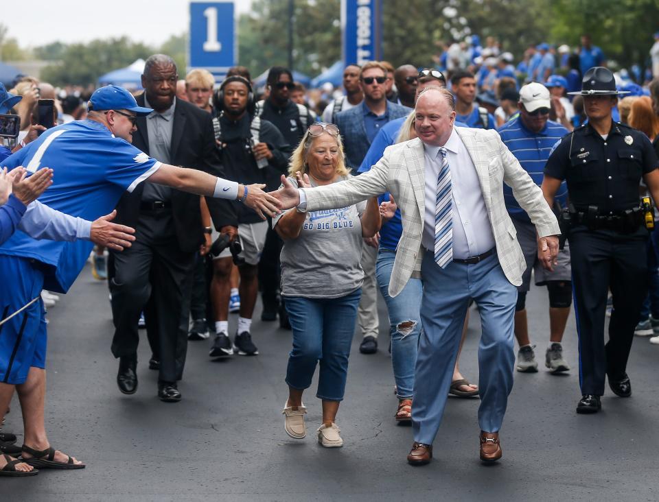 UK football coach Mark Stoops greets the Kentucky fans during the Cat Walk before the game against Eastern Kentucky on Sept. 9.