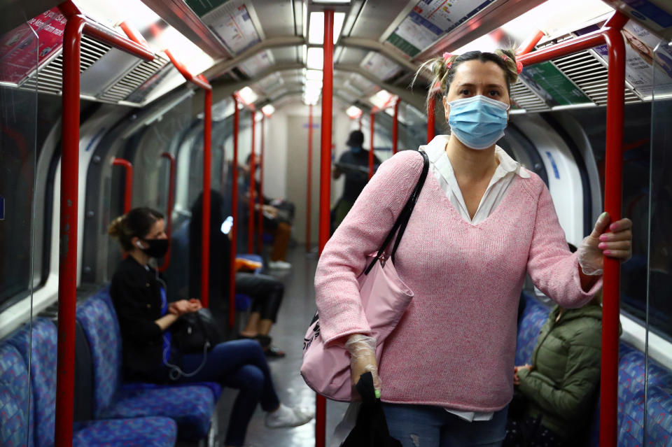A passenger wearing a face mask travels on the Central line tube, in London. Photo: Hannah McKay/Reuters