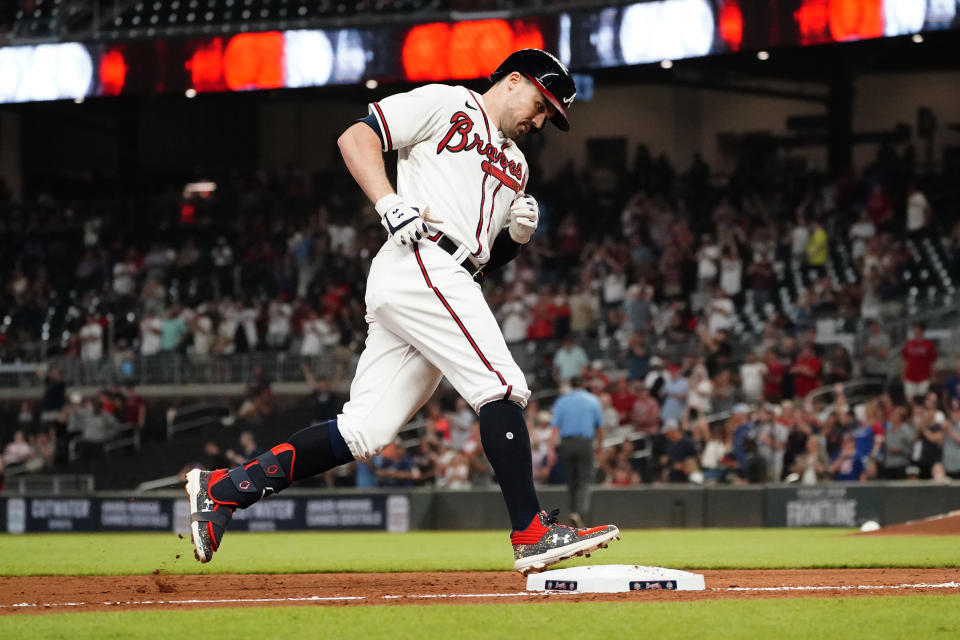 Atlanta Braves' Adam Duvall (14) rounds third base after hitting a two-run home run in the eighth inning of a baseball game against the Colorado Rockies Tuesday, Sept. 14, 2021, in Atlanta. (AP Photo/John Bazemore)