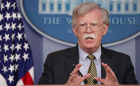 U.S. National Security Advisor John Bolton answers questions from reporters after announcing that the U.S. will withdraw from the Vienna protocol and the 1955 "Treaty of Amity" with Iran as White House Press Secretary Sarah Huckabee Sanders looks on during a news conference in the White House briefing room in Washington, U.S., October 3, 2018. REUTERS/Jonathan Ernst