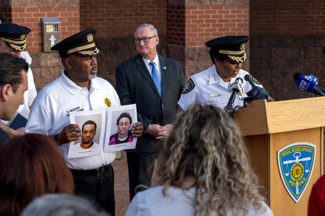 Department of Prisons Commissioner Blanche Carney, right, updates news media outside the Philadelphia Philadelphia Industrial Correctional Center Monday, May 8, 2023, on the recent escape of two prisoners as Mayor Jim Kenney is in rear, and Xavier Beaufort, left, Deputy Prisons Commissioner holds photos of the two escapees. Ameen Hurst, 18, and Nasir Grant, 24, escaped from the Philadelphia Industrial Correctional Center around 8:30 p.m. Sunday by cutting a hole in a fence surrounding a recreation yard, the Philadelphia Department of Prisons said. (Tom Gralish/The Philadelphia Inquirer via AP)