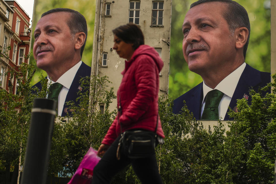 A person walks past billboards of Turkish President and People's Alliance's presidential candidate Recep Tayyip Erdogan a day after the presidential election day, in Istanbul, Turkey, Monday, May 15, 2023. Turkey's presidential elections appeared to be heading toward a second-round runoff on Monday, with President Recep Tayyip Erdogan, who has ruled his country with a firm grip for 20 years, leading over his chief challenger, but falling short of the votes needed for an outright win. (AP Photo/Emrah Gurel)