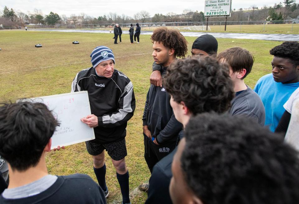 WORCESTER - Coach Bruce Mendelsohn teaches players during rugby practice Thursday, March 21, 2024.