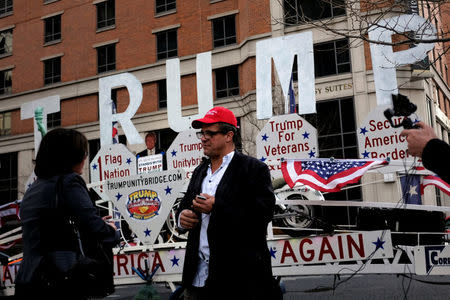 Rob Cortis of Detroit, Michigan talks with a passerby after parking his modified Trump Unity Bridge trailer in downtown Washington January 19, 2017. REUTERS/James Lawler Duggan