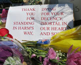 <p>A sign of thanks rests against a traffic light pole at a memorial outside the transit center in Portland, Ore. on Saturday, May 27, 2017. People stopped with flowers, candles, signs and painted rocks for two bystanders who were stabbed to death Friday, while trying to stop a man who was yelling anti-Muslim slurs and acting aggressively toward two young women, including one wearing a Muslim head covering, on a light-trail train in Portland. (AP Photo/Gillian Flaccus) </p>