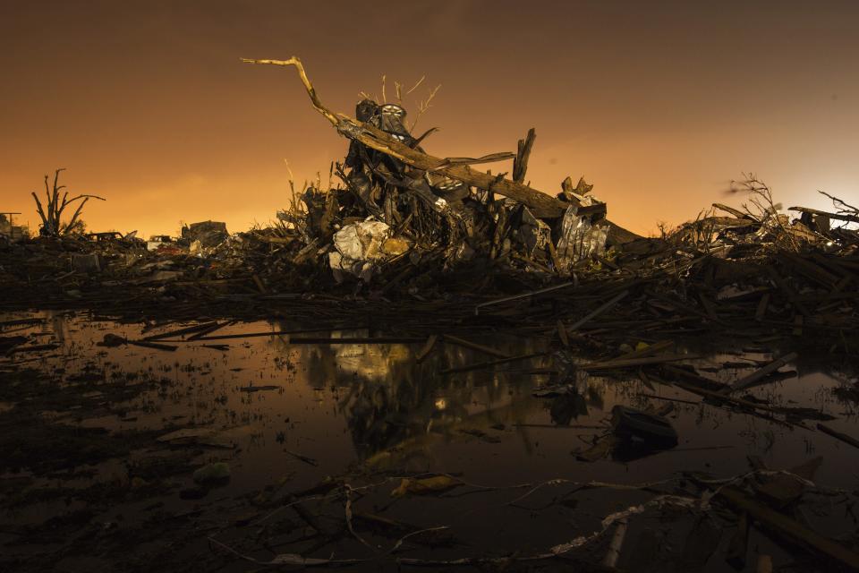 A car rests on top of a pile of debris pushed up by the wind in an area heavily damaged by the May 20 afternoon tornado in Moore, Oklahoma May 27, 2013. The tornado was the strongest in the United States in nearly two years and cut a path of destruction 17 miles (27 km) long and 1.3 (2 km) miles wide. (REUTERS/Lucas Jackson)