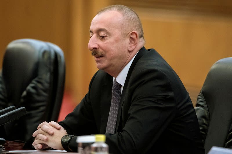 FILE PHOTO: Azerbaijan's President Ilham Aliyev speaks to Chinese President Xi Jinping during a meeting at the Great Hall of the People in Beijing