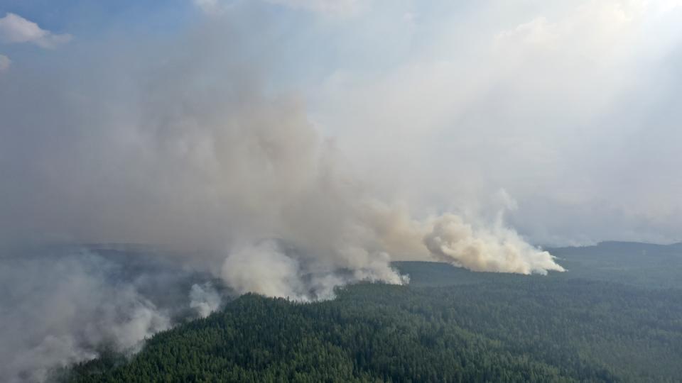 Smoke rises from a forest fire near the Syamozero Lake in Pryazhinsky District of the Republic of Karelia, about 700 km.(438 miles) south-west of Moscow, Russia on Wednesday, July 21, 2021. Volunteers have helped in Karelia as well. Anna Gorbunova, coordinator with the Society of Volunteer Forest Firefighters that focuses on the Ladoga Skerries national park in Karelia, told The Associated Press last week that the blazes there this year are the biggest since 2008. (AP Photo/Ilya Timin)