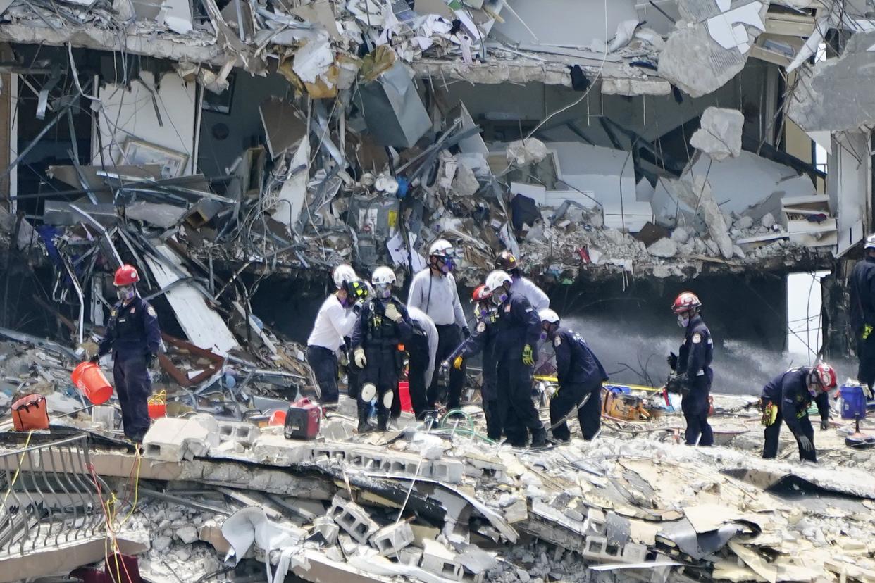 Rescue workers search in the rubble at the Champlain Towers South condominium, Saturday, June 26, 2021, in the Surfside area of Miami. The building partially collapsed on Thursday.
