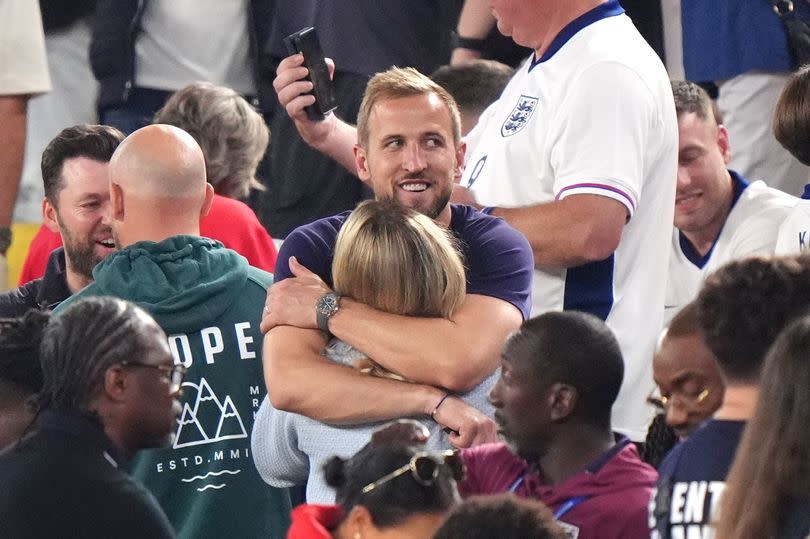 England's Harry Kane hugs wife Kate following their win