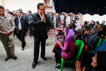 Thai Prime Minister Prayuth Chan-ocha gestures in traditional greeting during a visit at Ra-ngae district in the troubled southern province of Narathiwat, Thailand, January 6, 2017. REUTERS/Surapan Boonthanom