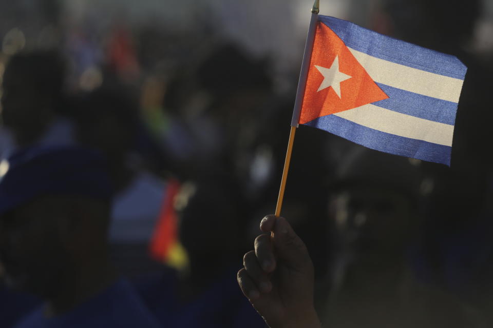 A person waves a Cuban flag during a gathering marking International Workers' Day at Jose Marti Anti-Imperialist Square in Havana, Cuba, Wednesday, May 1, 2024. (AP Photo/Ariel Ley)