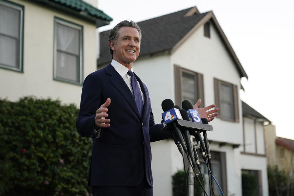 California Gov. Gavin Newson speaks to reporters outside the home of Brandon Tsay, 26, after meeting with him on Monday, Jan. 23, 2023, in San Marino, Calif. Tsay disarmed a gunman who killed multiple people late Saturday amid Lunar New Years celebrations in the predominantly Asian American community of Monterey Park. The gunman started at the Star Ballroom Dance Studio in Monterey Park and continued to Lai Lai Ballroom and Studio in Alhambra, where he was disarmed by Tsay. (AP Photo/Ashley Landis)