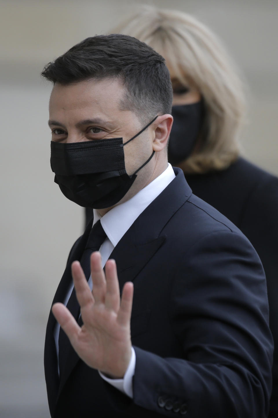 Ukrainian President Volodymyr Zelenskyy gestures as he arrives at the Elysee palace in Paris, Friday, April 16, 2021. Ukrainian President Volodymyr Zelenskyy is holding talks with French President Emmanuel Macron and German Chancellor Angela Merkel amid growing tensions with Russia, which has deployed troops at the border with the country. (AP Photo/Lewis Joly)