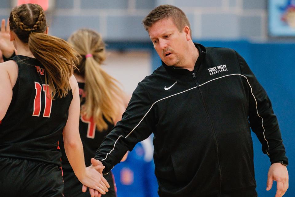 Tusky Valley's head coach low five's starter Cara Stump near the end of the first half during their game against Garaway Wednesday, Dec. 1, 2021 in Sugarcreek.