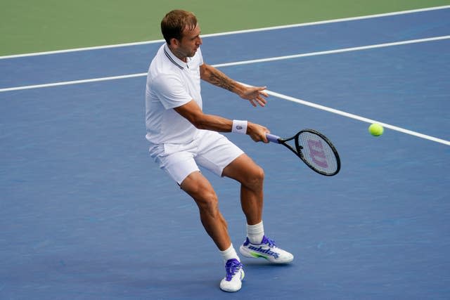 Dan Evans plays a forehand during his five-set win