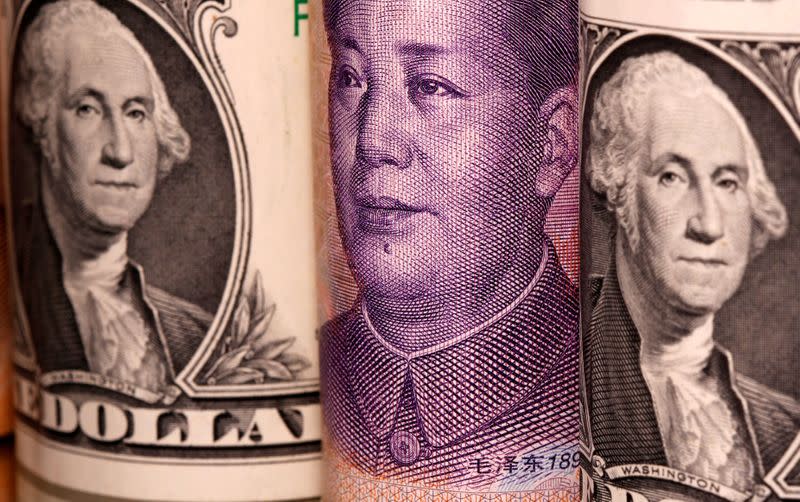 Chinese Yuan and U.S. dollar banknotes are seen in this illustration