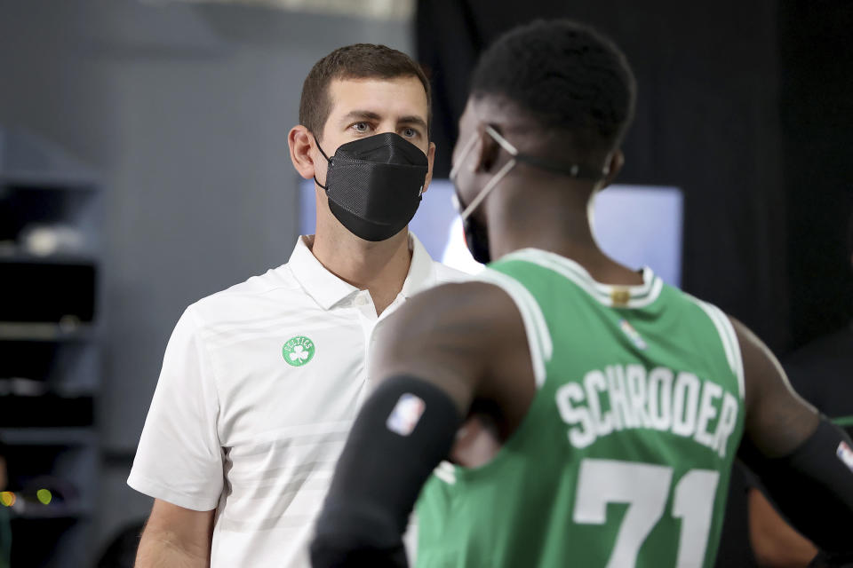 Brad Stevens, Boston Celtics President of Basketball Operations, speaks with Dennis Schroder at the Boston Celtics Media Day, Monday, Sept. 27, 2021, in Canton, Mass. (AP Photo/Mary Schwalm)