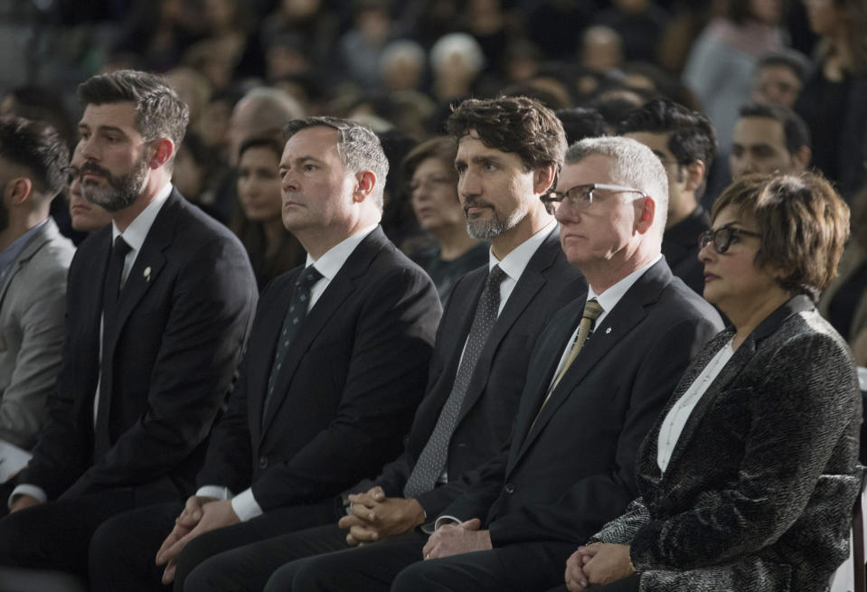 Edmonton Mayor Don Iveson, Alberta Premier Jason Kenney, Prime Minister Justin Trudeau and University of Alberta President David Turpin listens to a speech during a memorial for the victims of the recent Ukrainian plane crash in Iran, in Edmonton, Sunday, Jan. 12, 2020. (Todd Korol/The Canadian Press via AP)