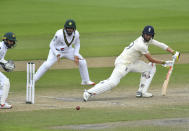 England's Chris Woakes, right, bats during the fourth day of the first cricket Test match between England and Pakistan at Old Trafford in Manchester, England, Saturday, Aug. 8, 2020. (Dan Mullan/Pool via AP)