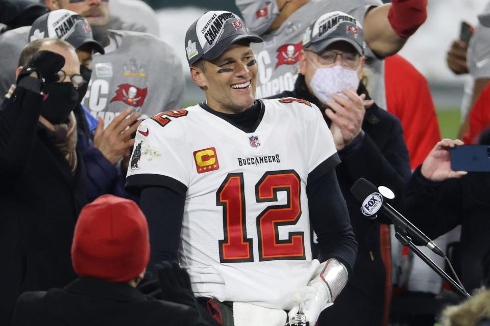 GREEN BAY, WISCONSIN - JANUARY 24: Tom Brady #12 of the Tampa Bay Buccaneers celebrates with teammates after their 31 to 26 win over the Green Bay Packers during the NFC Championship game at Lambeau Field on January 24, 2021 in Green Bay, Wisconsin. (Photo by Dylan Buell/Getty Images)