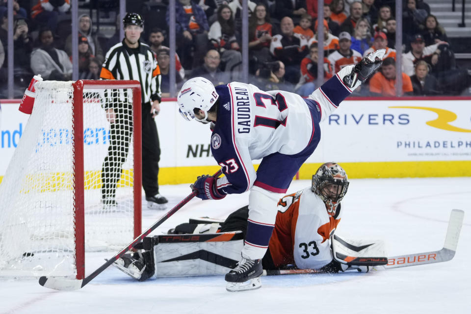 Columbus Blue Jackets' Johnny Gaudreau (13) scores a goal against Philadelphia Flyers' Samuel Ersson (33) during a shootout in an NHL hockey game, Thursday, Jan. 4, 2024, in Philadelphia. (AP Photo/Matt Slocum)