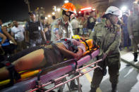 <p>Firefighters carry a woman on a stretcher after a car drove into the crowded seaside boardwalk along Copacabana beach in Rio de Janeiro, Brazil, Thursday, Jan. 18, 2018. (Photo: Silvia Izquierdo/AP) </p>