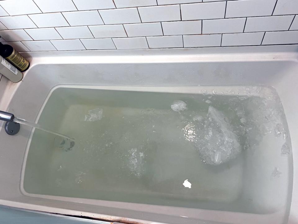 bathtub filled with water and ice