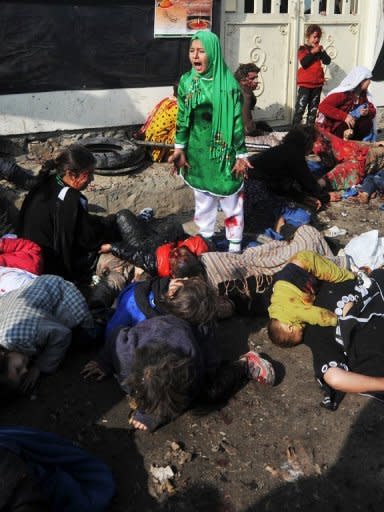 Tarana (R), 12, reacts while surrounded by the bodies of men, women and children who died after a suicide bomber detonated a bomb during a religious ceremony in Kabul in December, 2011. The photographer, Massoud Hossaini, won the prestigious Pulitzer Prize for the image