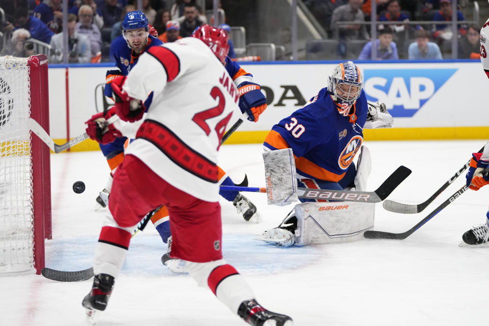 New York Islanders goaltender Ilya Sorokin (30) watches as Carolina Hurricanes' Seth Jarvis (24) scores a goal during the first period of Game 4 of an NHL hockey Stanley Cup first-round playoff series, Sunday, April 23, 2023, in Elmont, N.Y. (AP Photo/Frank Franklin II)