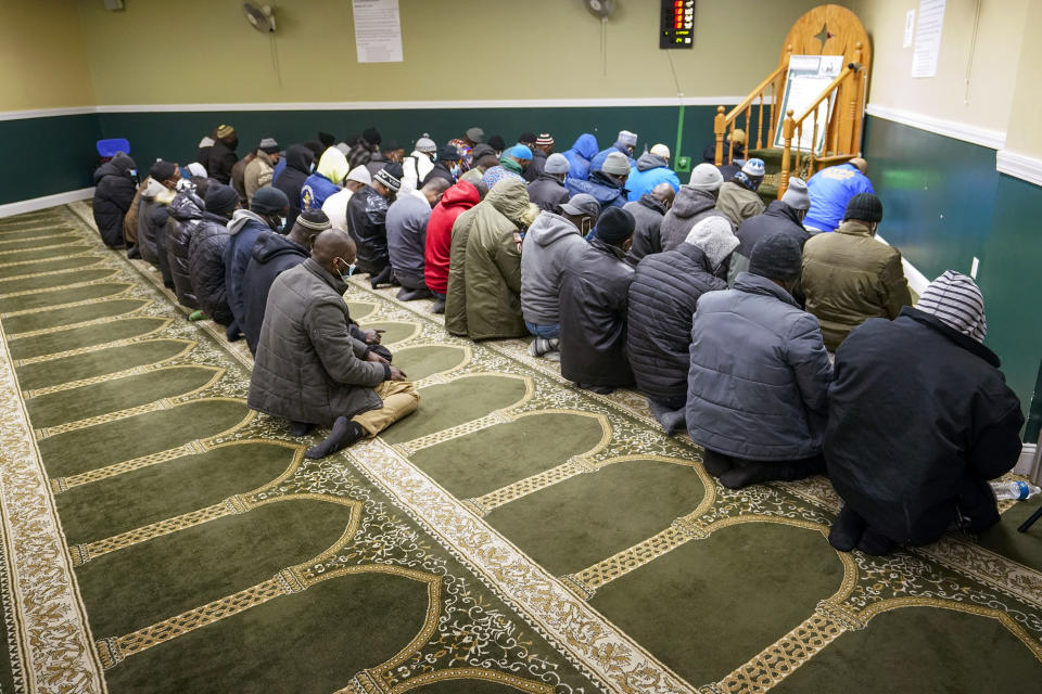 Members of the Masjid Ar Rahman pray, in the Bronx borough of New York, Wednesday, Jan. 12, 2022. The Mosque is a place of worship for some of the residents of the building which suffered the New York City's deadliest fire in three decades. (AP Photo/Mary Altaffer)