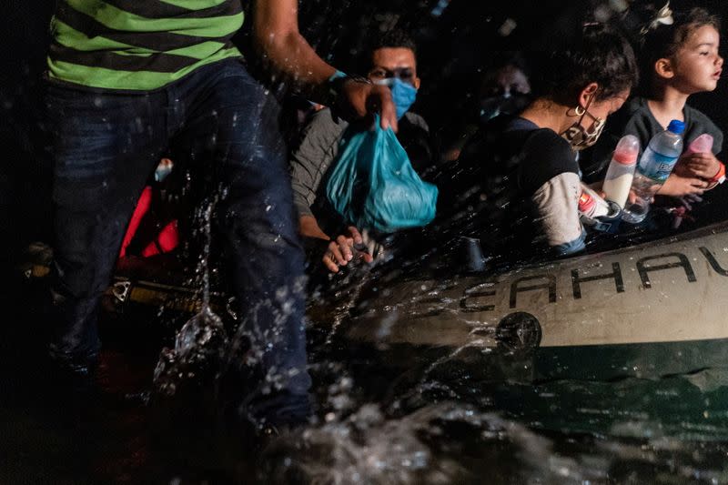 Asylum-seeking migrants cross the Rio Grande river in Roma, Texas