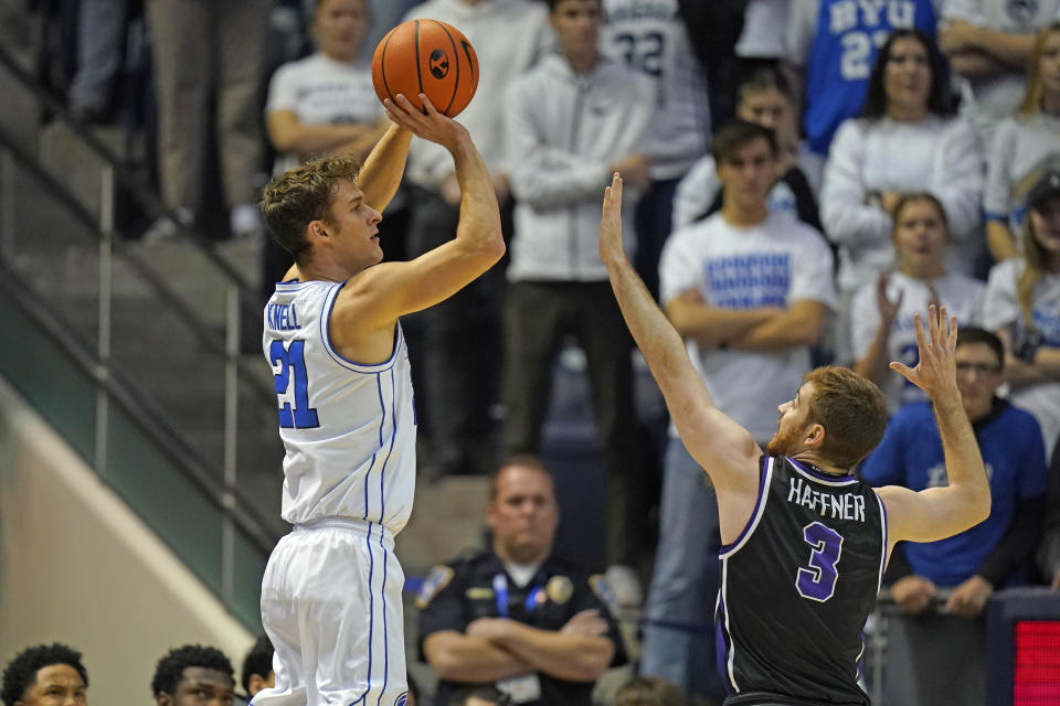 BYU guard Trevin Knell (21) shoots as Evansville guard Cameron Haffner (3) defends during the first half of an NCAA college basketball game Tuesday, Dec. 5, 2023, in Provo, Utah. (AP Photo/Rick Bowmer)