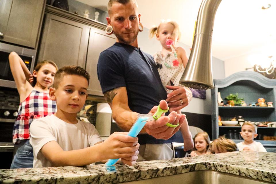 High rents continue to bedevil Floridians. Kurt Ziegler opens a popsicle for one of his six kids. The family lived in a new construction home in Cape Coral when their landlords raised their rent by over $1,000.