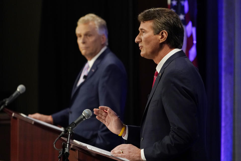 Republican gubernatorial candidate Glenn Youngkin, right, gestures as Democratic gubernatorial candidate former Governor Terry McAuliffe, left, listens during a debate at the Appalachian School of Law in Grundy, Va., Thursday, Sept. 16, 2021. (AP Photo/Steve Helber)