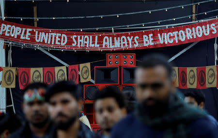 People watch artists performing on a stage at an event titled "Artists Unite", during which various artists signed to register their concern against hate and intolerance, at a public park in New Delhi, March 2, 2019. REUTERS/Anushree Fadnavis/Files