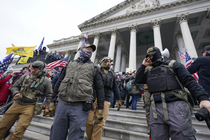 FILE - Members of the Oath Keepers stand on the East Front of the U.S. Capitol on Jan. 6, 2021, in Washington. The trial of the founder of the Oath Keepers, Stewart Rhodes, and four associates charged with seditious conspiracy in the attack on the U.S. Capitol is set to begin next week. (AP Photo/Manuel Balce Ceneta, File)