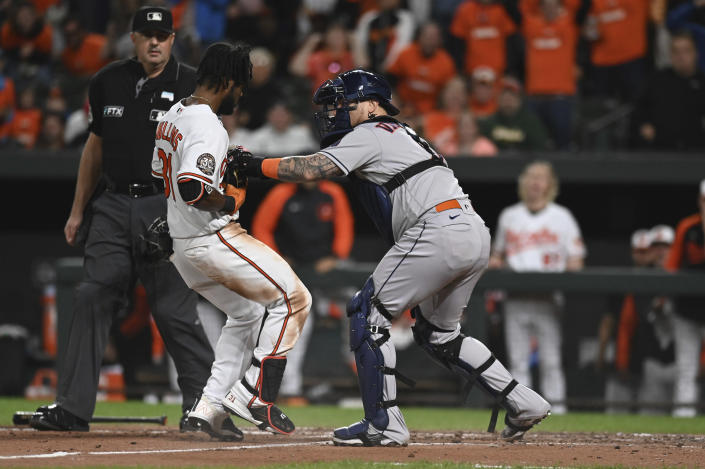 Houston Astros catcher Christian Vazquez tags out Baltimore Orioles' Cedric Mullins at home plate during the fifth inning of a baseball game Thursday, Sept. 22, 2022, in Baltimore. (AP Photo/Tommy Gilligan)