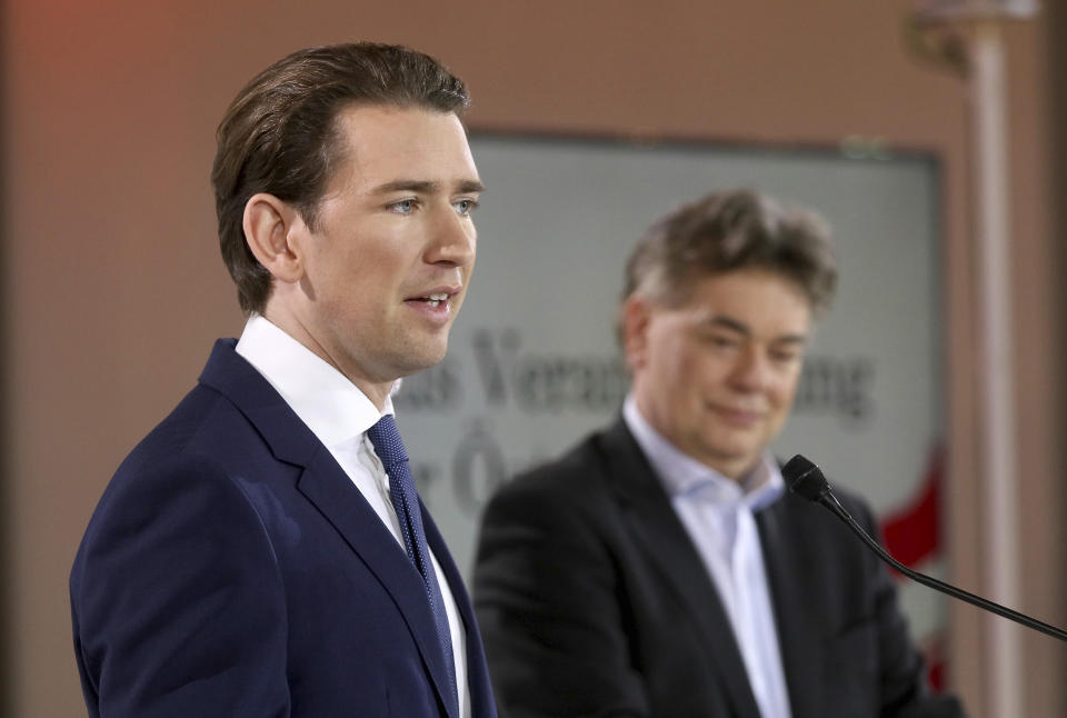 Sebastian Kurz, left, head of the Austrian People's Party, OEVP, and Werner Kogler, right, head of the Austrian Greens speak to journalists during a press conference about the government program in Vienna, Austria, Thursday, Jan. 2, 2020. (AP Photo/Ronald Zak)
