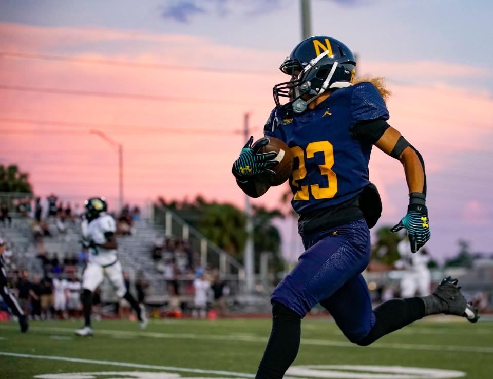Naples Golden Eagles punt returner Ty Collins (23) runs the ball for a touchdown during the first quarter of a district game against the Golden Gate Titans at Staver Field in Naples on Thursday, Sept. 14, 2023.