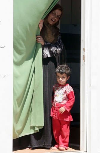 Syrian refugees stand at Turkey's Kilis refugee camp near the Syrian border. Refugee camps in the southeastern provinces of Hatay, Gaziantep, Sanliurfa and Kilis shelter nearly 31,000 Syrians